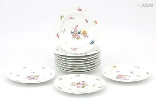 Twelve porcelain plates with polychrome decoration of flower...