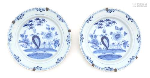 A pair of blue and white Delft earthenwarewall plates with C...