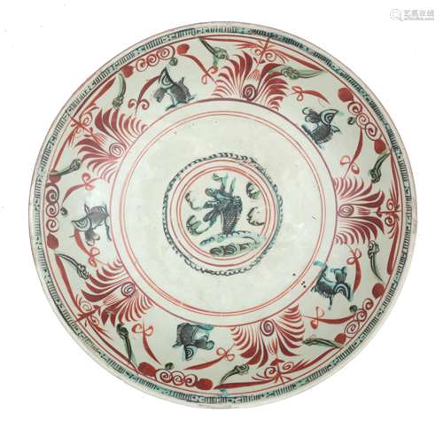 A Chinese Swatow dish decorated with fish in turquoise surro...