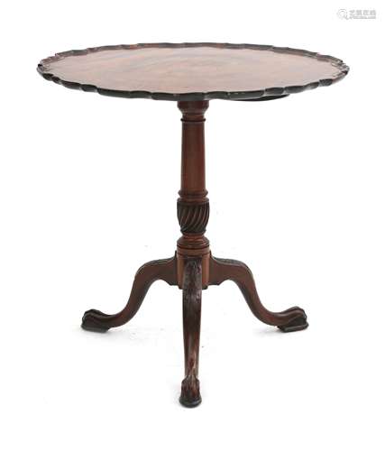 A mahogany foldover tea table with profiled edge, baluster t...