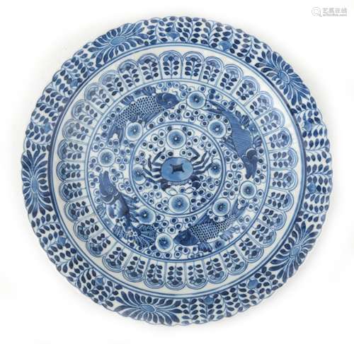 A Chinese blue and white porcelain plate with stylized flora...