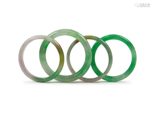 GROUP OF FOUR JADEITE BANGLES