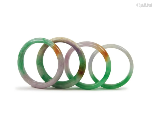 GROUP OF FOUR JADEITE BANGLES