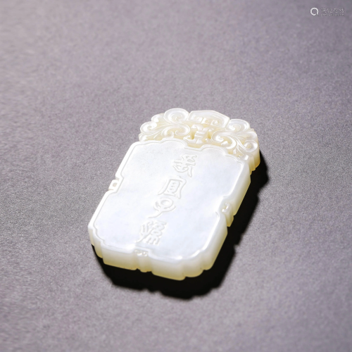 A CARVED WHITE JADE PENDANT WITH SCRIPT