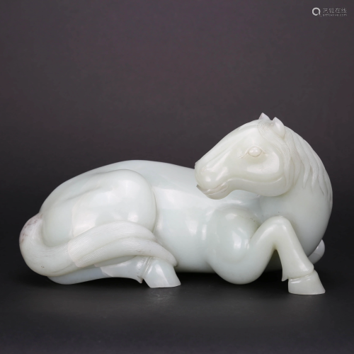 A CARVED WHITE JADE FIGURE OF RECUMBENT HORSE