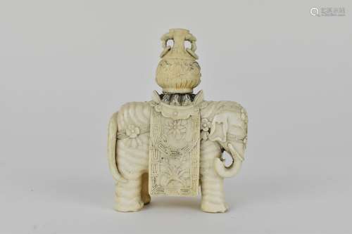 A Chinese carved ivory model elephant decorated with flowers...