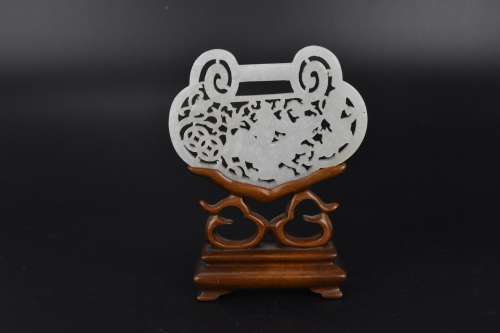 A Chinese late Qing dynasty white jade reticulated plaque on...