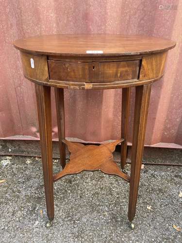 A George III mahogany oval table with a frieze drawer, on sq...