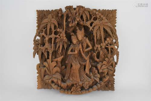 A 20th century Thai carved wooden panel decorated with a cen...