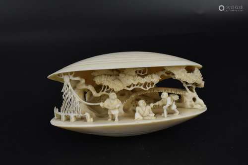 A Japanese Meiji period ivory clam shell okimono with carved...