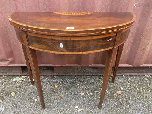 A George III mahogany and marquetry card table, with a foldo...