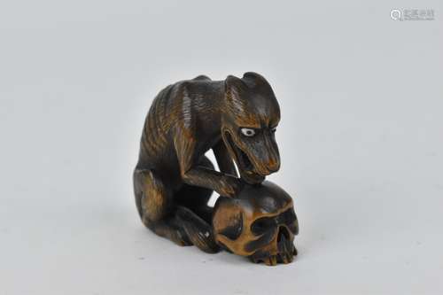 A Japanese carved wood netsuke, 19th century, modelled as a ...