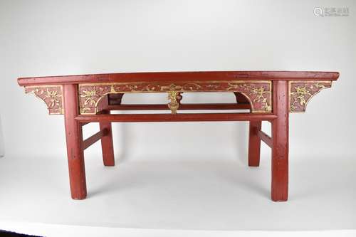 A late 20th century Chinese red painted opium table with a b...