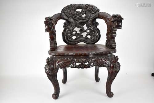 A Chinese late 19th century carved wooden chair with a centr...