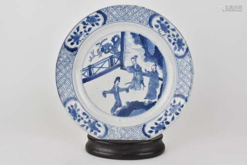 A Chinese Kangxi blue and white plate decorated with ladies ...