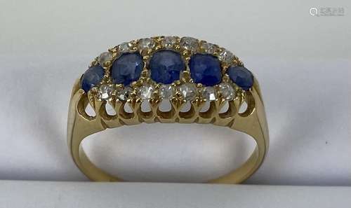 An 18ct yellow gold ring set with five blue sapphires, large...