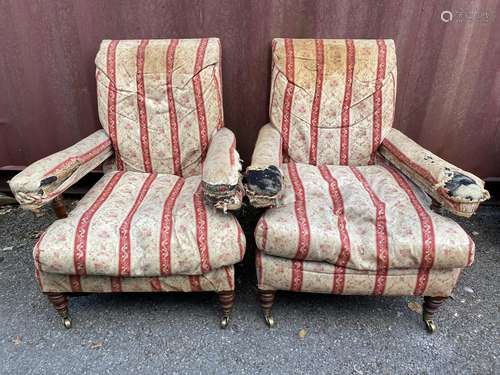 A pair of late 19th century Howard & Son armchairs of low pr...