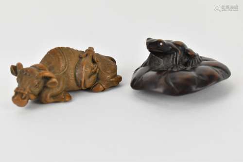 Two early 20th century Japanese wood netsuke of a recumbent ...