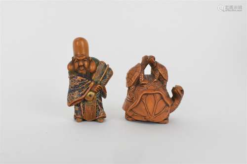 A Quin dynasty and a later wooden netsuke of a deity wearing...