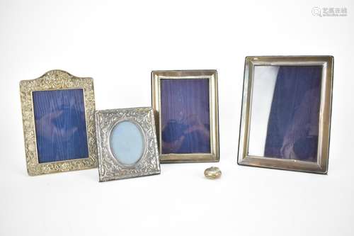 Four late 20th century silver photograph frames, two with em...