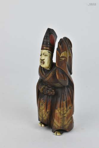 A Japanese Meiji period fruitwood and ivory okimono, modelle...