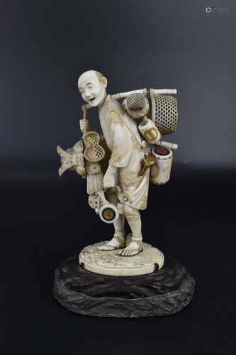 A Japanese Meiji period ivory okimono of a pedlar, well carv...