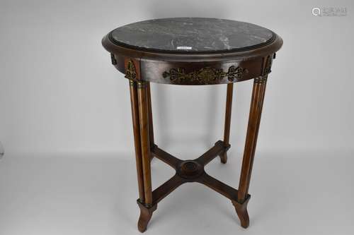 An early 19th century French walnut table with gilt metal mo...