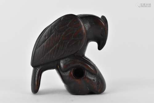 A Japanese Edo period, 18th century wooden netsuke of a bird...