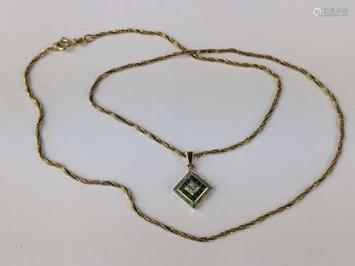 A 9ct gold pendant set with diamonds and green stones, possi...