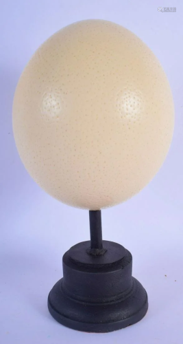 AN OSTRICH EGG on stand. Egg 14 cm x 11 cm.