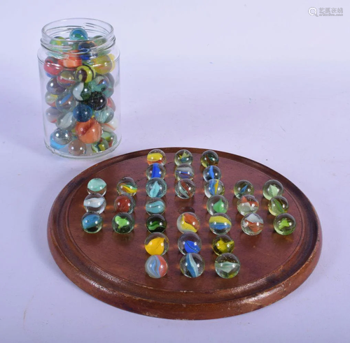 A SOLITAIRE MARBLE BOARD with associated marbles. (qty)