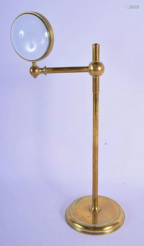 A STYLISH EARLY 20TH CENTURY BRASS MAGNIFYING LENS…