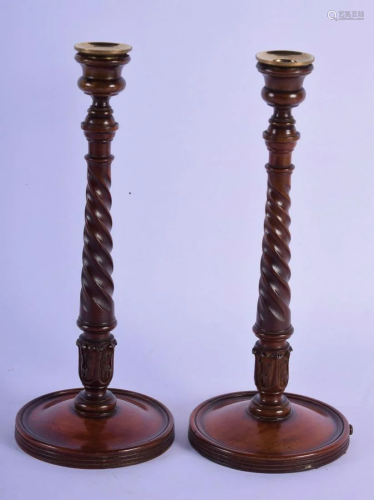 A PAIR OF ANTIQUE TURNED WOOD CANDLESTICKS. 36 cm high.