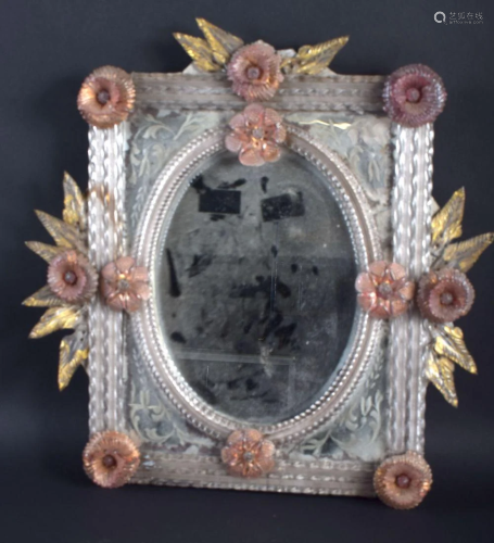 AN ANTIQUE VENETIAN GLASS MIRROR overlaid with foliage