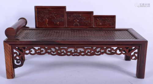 A CHINESE CARVED HARDWOOD MINIATURE DAY BED S…