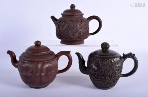 THREE YIXING POTTERY TEAPOTS AND COVERS probably