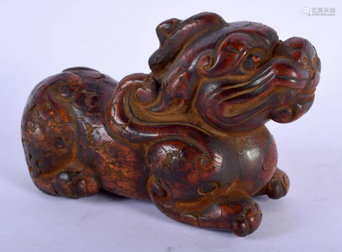 AN UNUSUAL LACQUERED FIGURE OF A BUDDHISTIC LION 20th