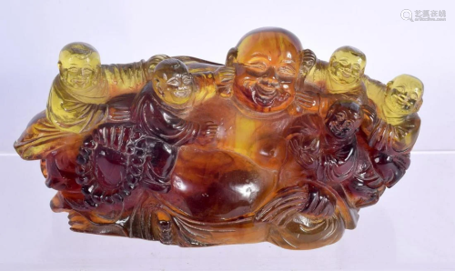 A CHINESE CARVED AMBER TYPE BUDDHA BOULDER. 18 cm x 12