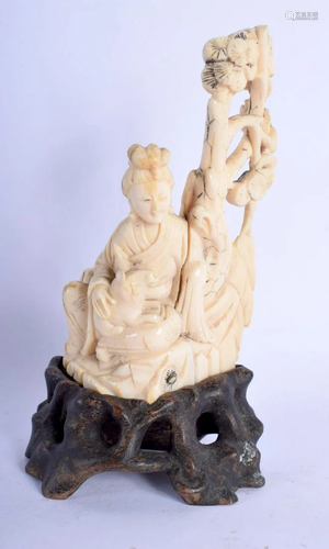 A CHINESE QING DYNASTY CARVED IVORY FIGURE OF A SEATED