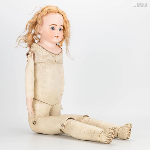 An antique doll with porcelain head and hands, leather