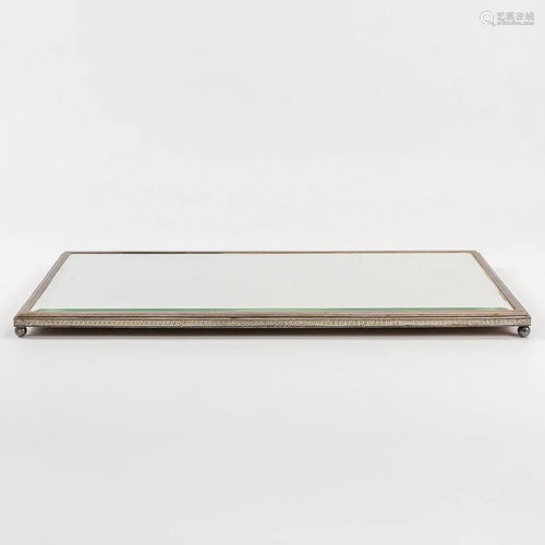 A table mirror or centerpiece with silver-plated edge.