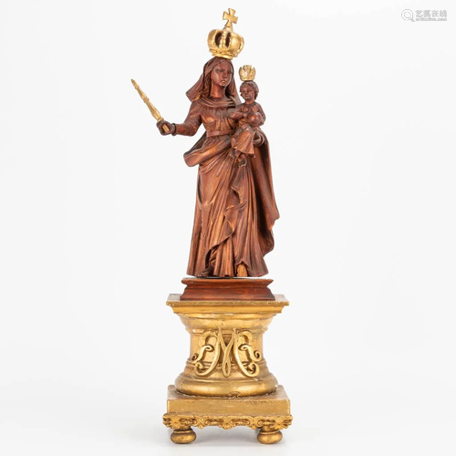 An antique wood sculptured statue of Madonna with