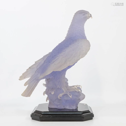 Decorative figurine of an eagle, standing on a wood