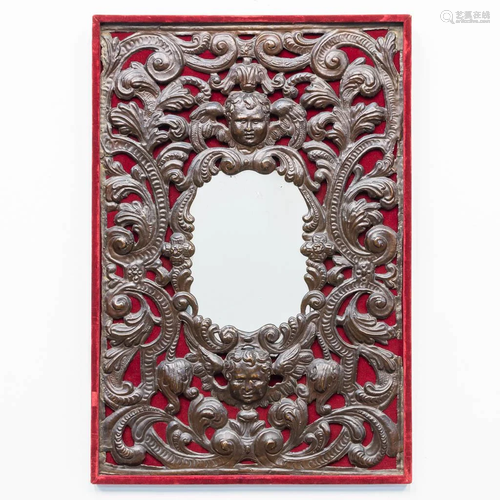 A mirror with a frame made of bronze/copper, with