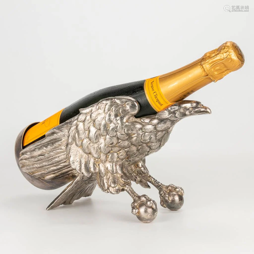 A silver-plated champagne bottle holder in the shape of