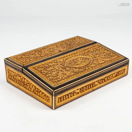 An Oriental writing box with hand-sculptured decors.