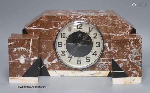 An Art Deco rouge marble clock garniture, length 36cm