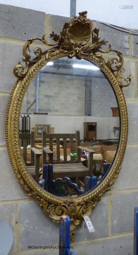 A Victorian giltwood and gesso oval wall mirror, width 58cm,...