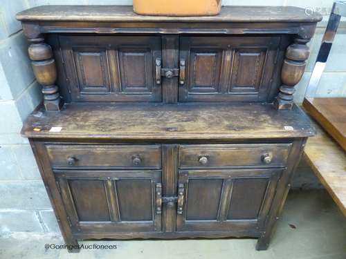 An Ercol oak court cupboard, length 122cm, depth 45cm, heigh...