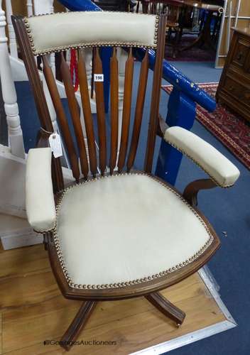 A late 19th century mahogany and cream leather swivel and ro...